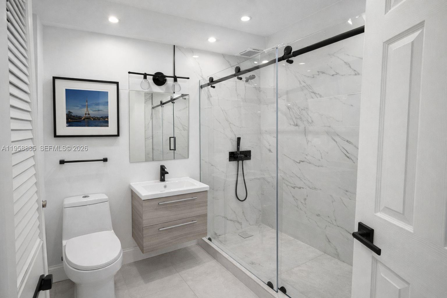 880 Northeast 69th Street, Unit 2N Miami, FL 33138 - Photo 23 of 23 a bathroom with a toilet sink and shower