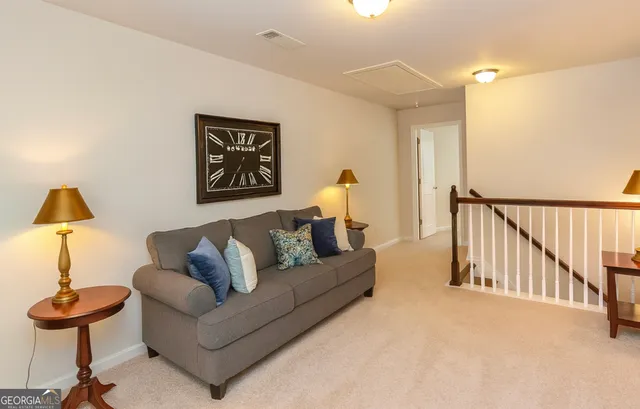 a living room with furniture and a lamp