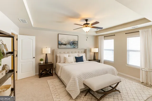 a bedroom with a bed a chandelier and closet