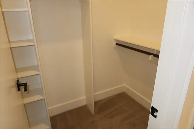 a view of a room with a window and a ceiling fan