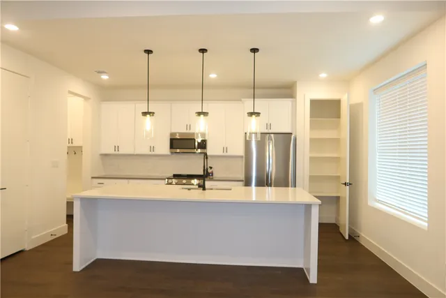a bathroom with a sink a mirror and shower