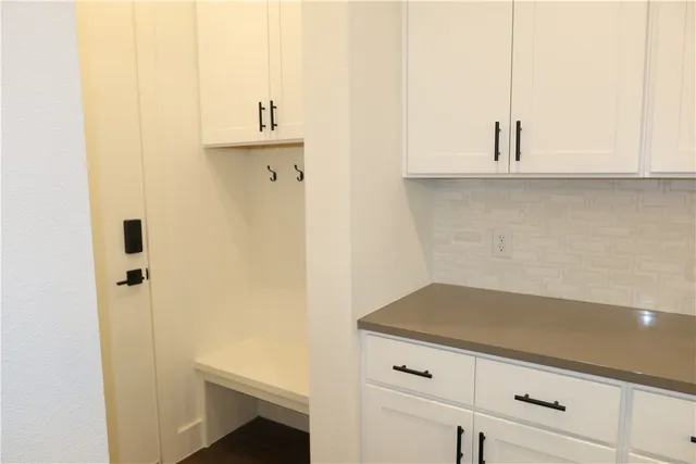 a kitchen with a sink a counter and a dining table