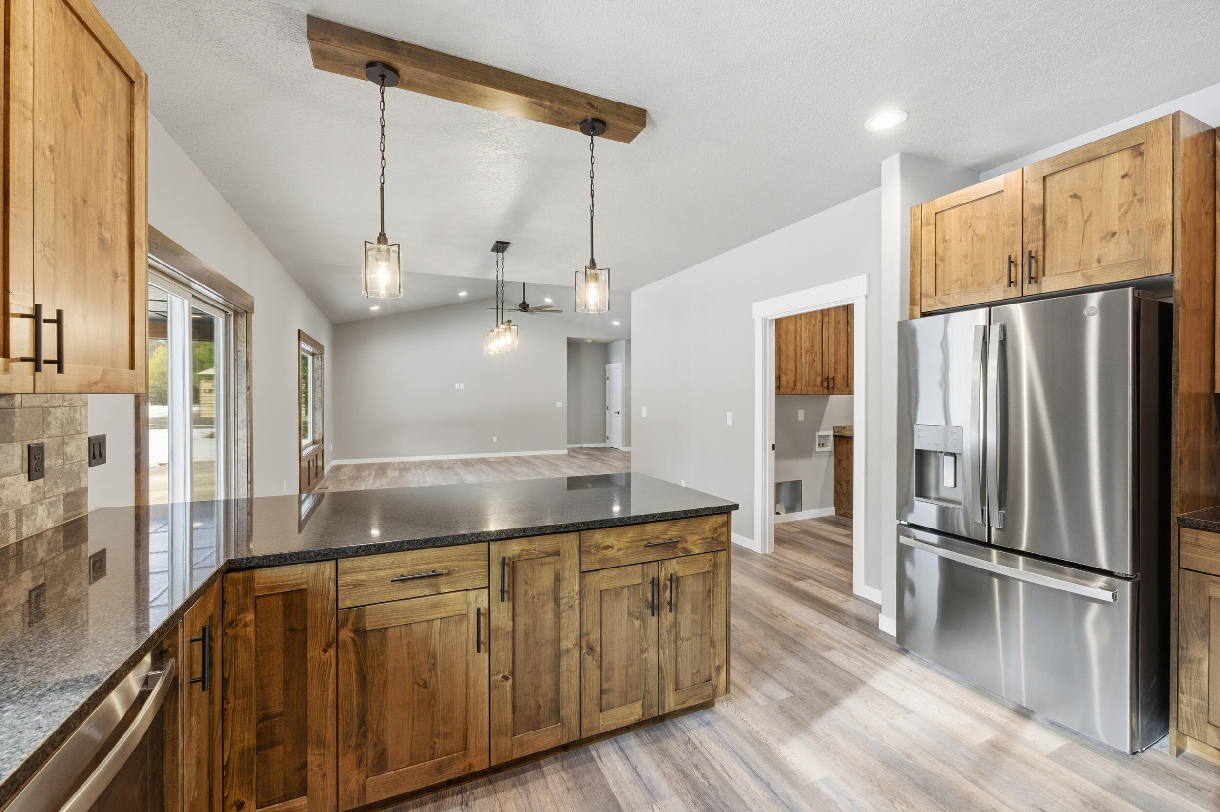 16083 Dyke Road, Unit 9 La Pine, OR 97739 - Photo 13 of 53 a kitchen with kitchen island a counter top space wooden floor and stainless steel appliances