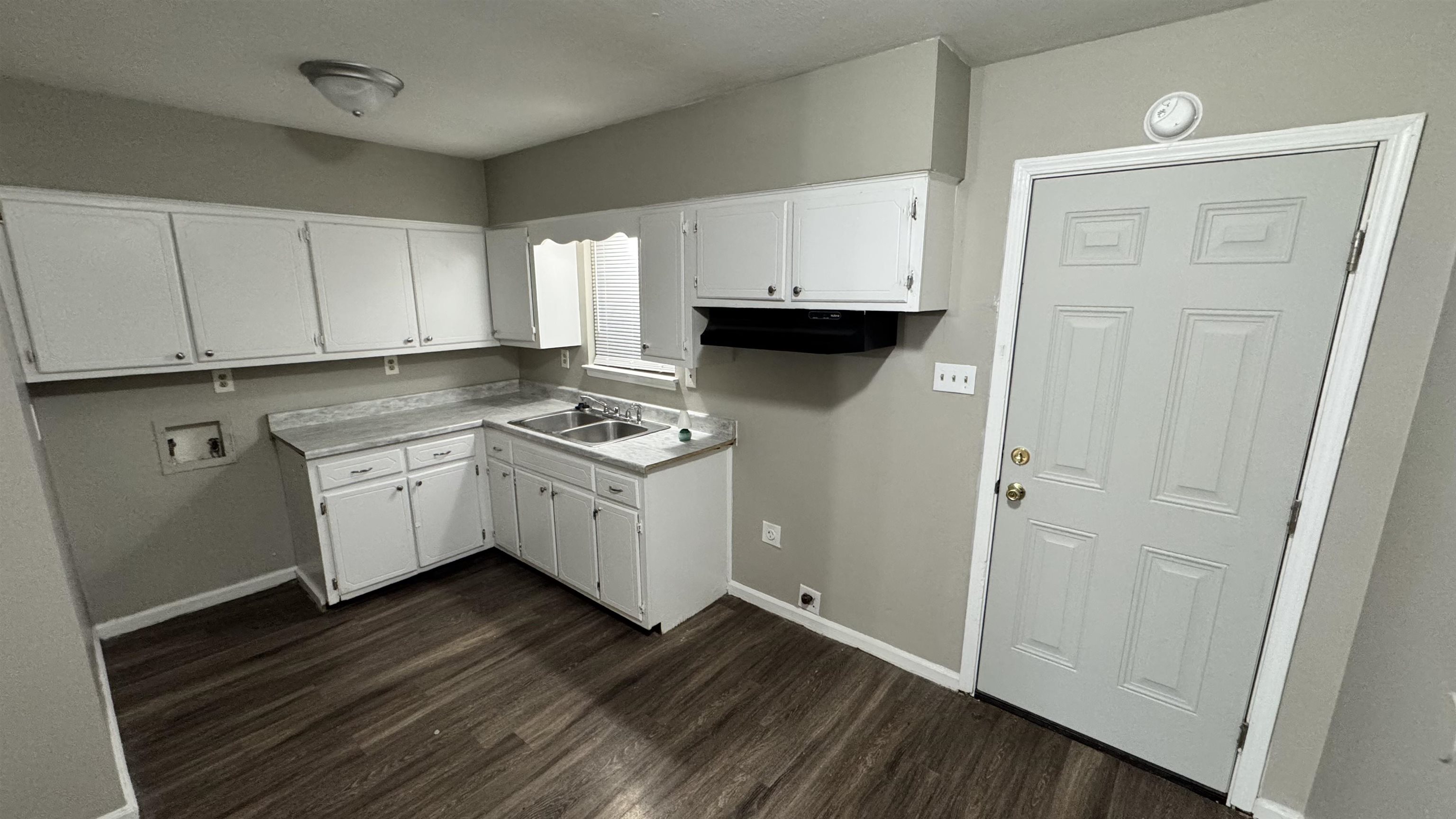 3556 Arnold Road Memphis, TN 38118 - Photo 2 of 3 a kitchen with sink cabinets and wooden floor