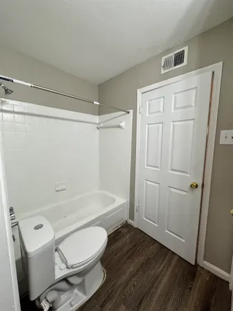 a bathroom with a toilet a sink and bathtub