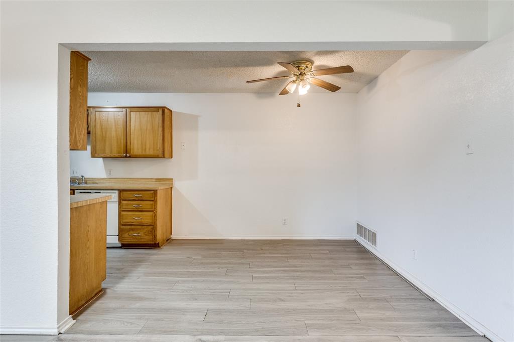 1913 San Rafael Street Fort Worth, TX 76134 - Photo 5 of 12 a view of a livingroom with wooden floor and a ceiling fan