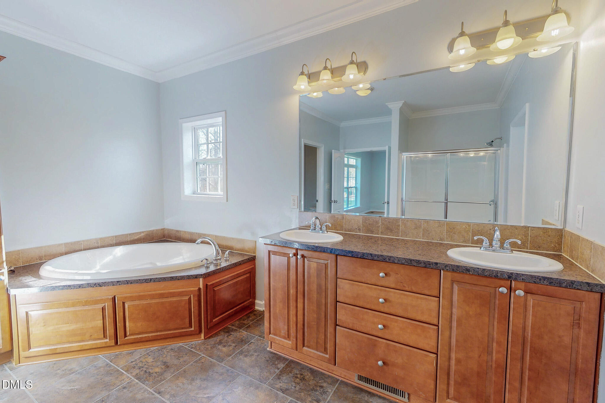 471 Parham Road Roxboro, NC 27574 - Photo 32 of 92 a spacious bathroom with a granite countertop double vanity sink a mirror and a bathtub