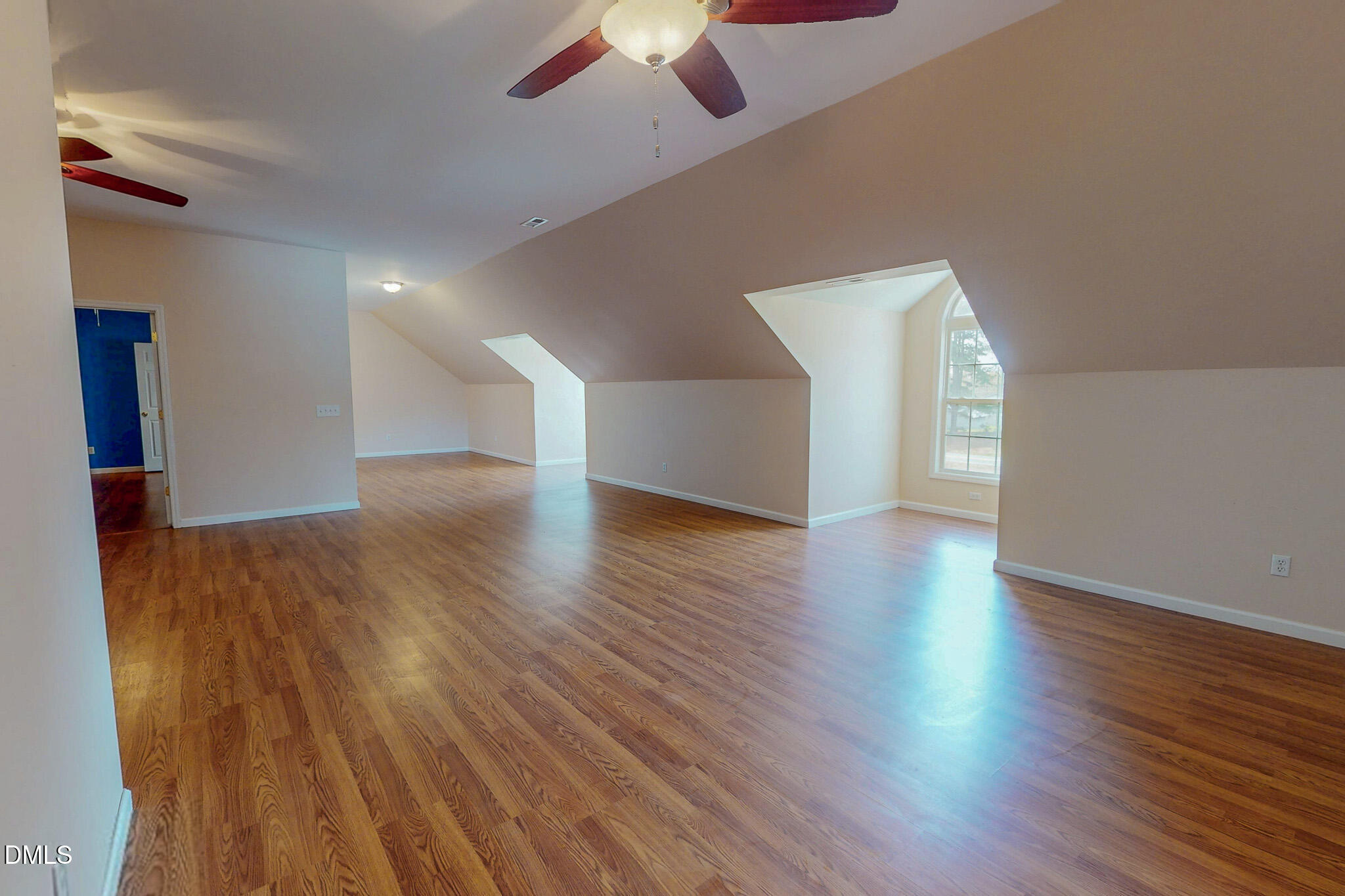 471 Parham Road Roxboro, NC 27574 - Photo 77 of 92 a view of an empty room with wooden floor and a ceiling fan