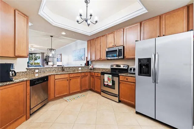 a bedroom with a large bed and a flat tv screen on dresser