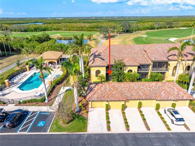 an aerial view of residential houses with outdoor space and swimming pool
