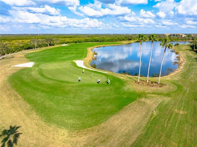 an aerial view of a swimming pool patio and mountain view in back
