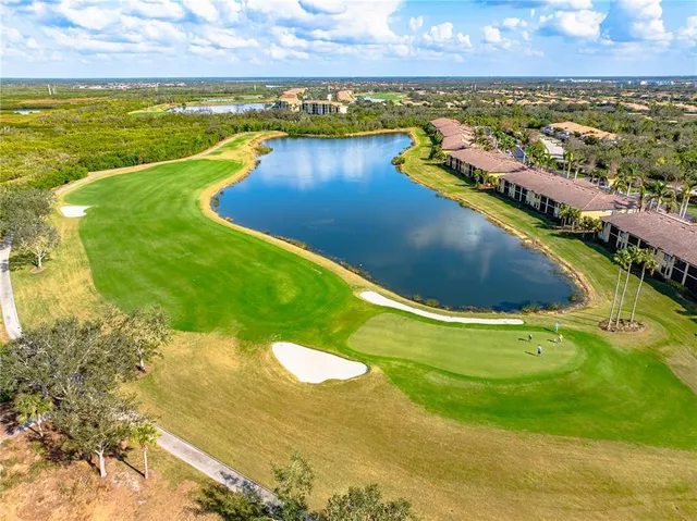 an aerial view of a houses with outdoor space swimming pool and ocean view