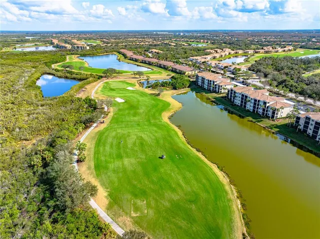 a view of a fountain in front of a house with a big yard