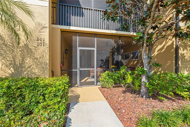 a kitchen with stainless steel appliances a table and chairs in it