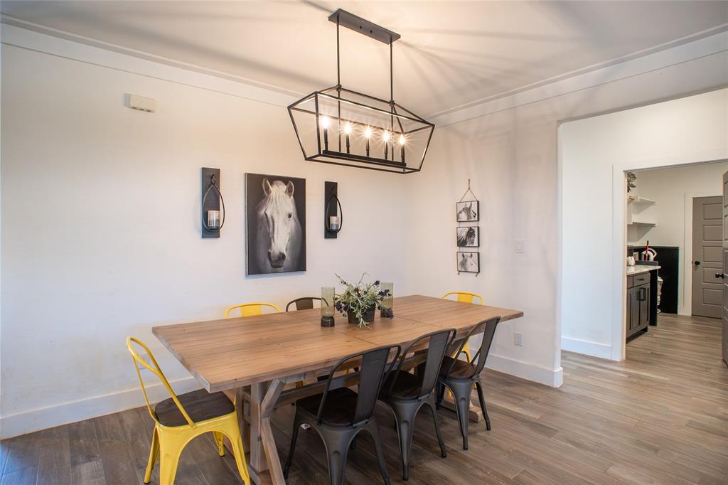 311 Dobbs Trail Springtown, TX 76082 - Photo 13 of 33 a view of a dining room with furniture wooden floor and chandelier