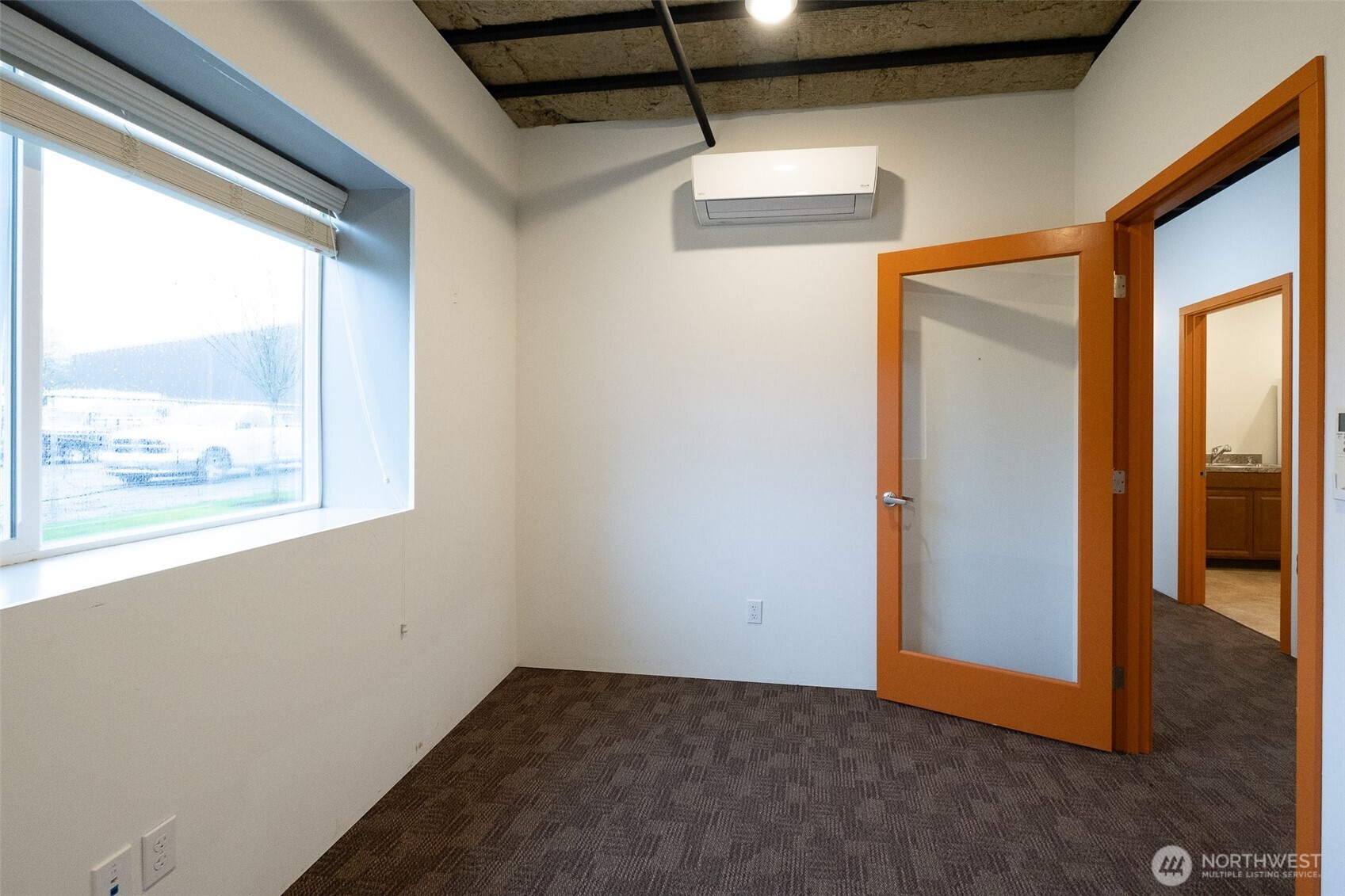 12375 Reservation Road Anacortes, WA 98221 - Photo 23 of 40 a view of a room with wooden floor and windows