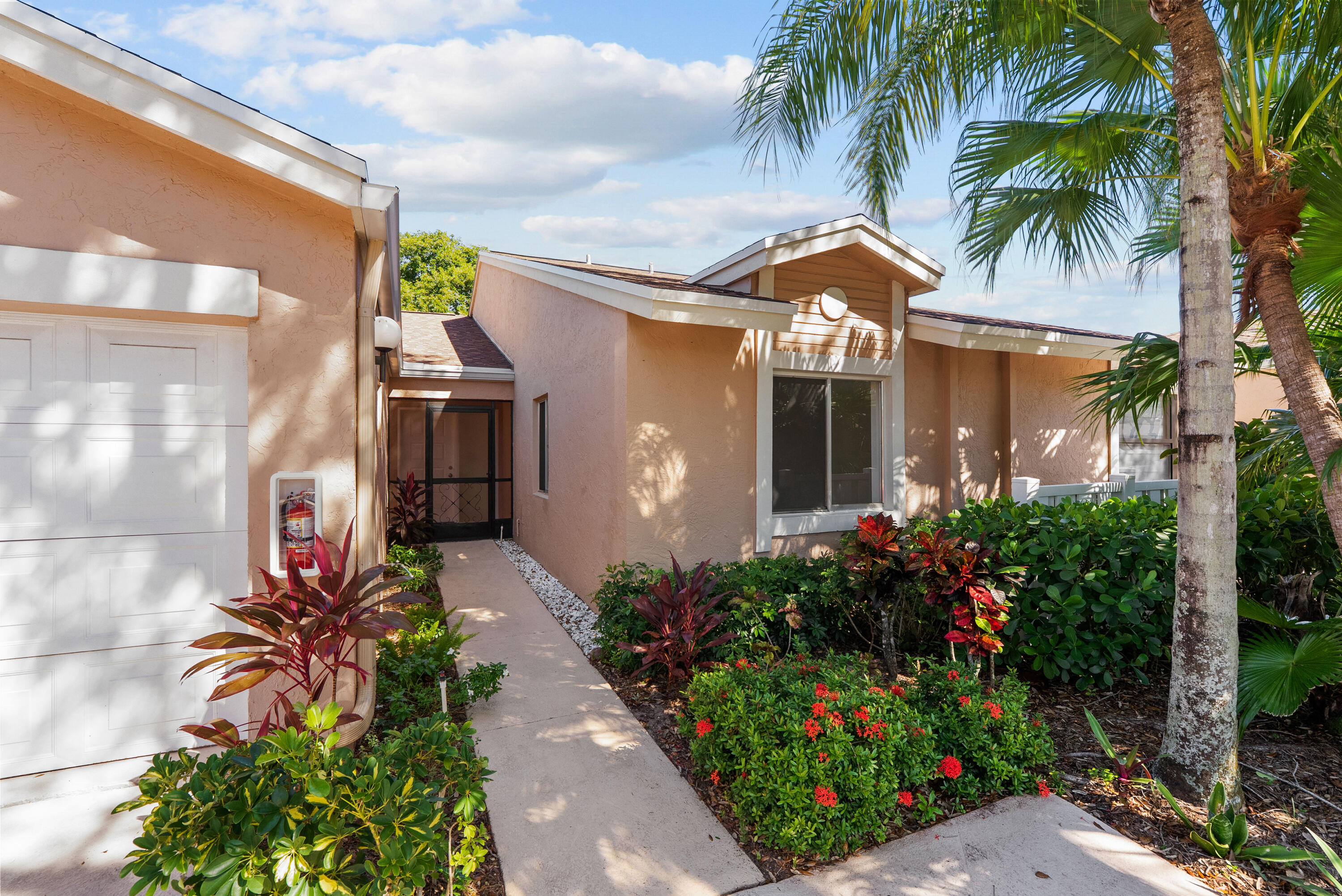 8273 Springtree Road Boca Raton, FL 33496 - Photo 12 of 36 a front view of a house with a yard