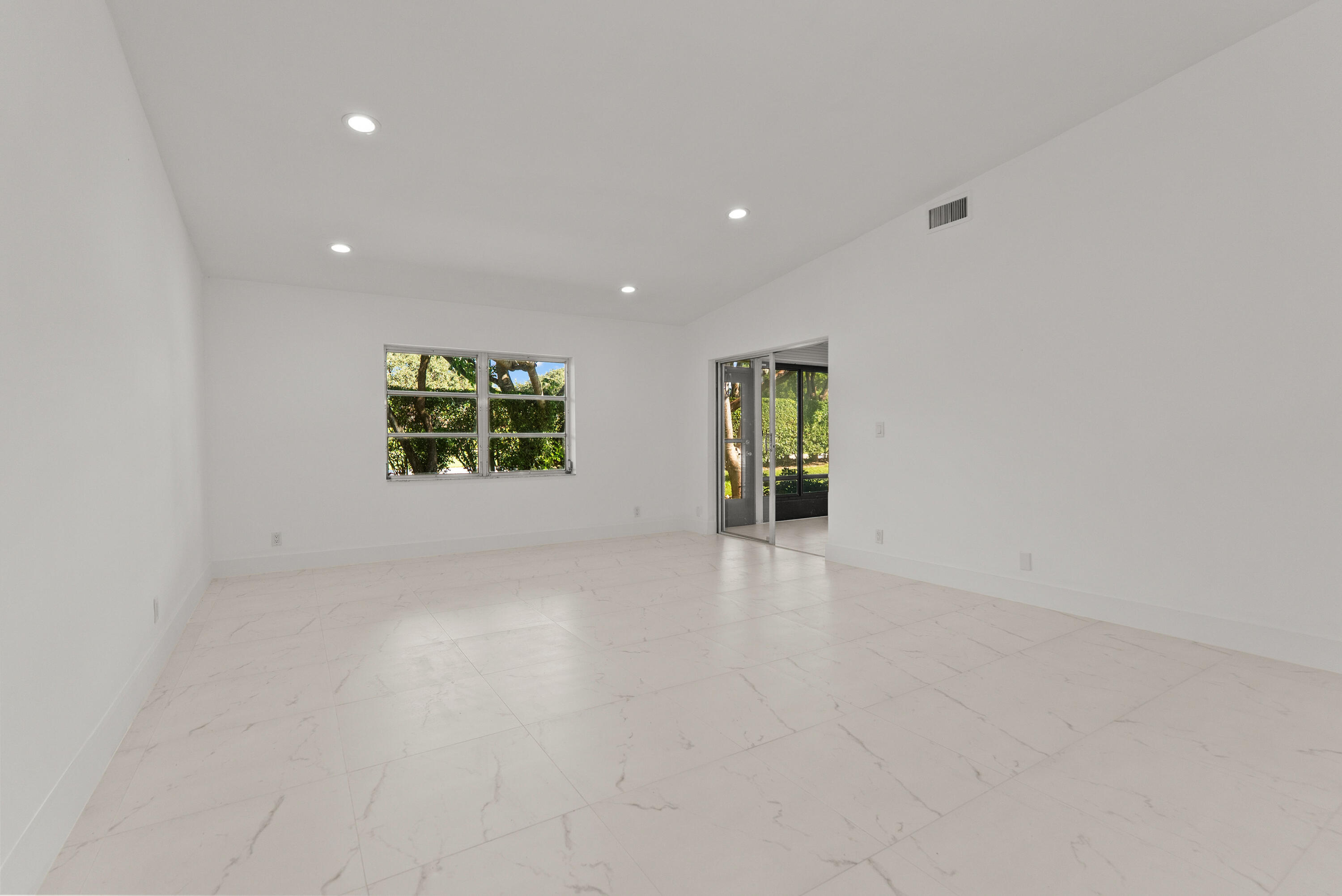 8273 Springtree Road Boca Raton, FL 33496 - Photo 21 of 36 wooden floor in an empty room with a window