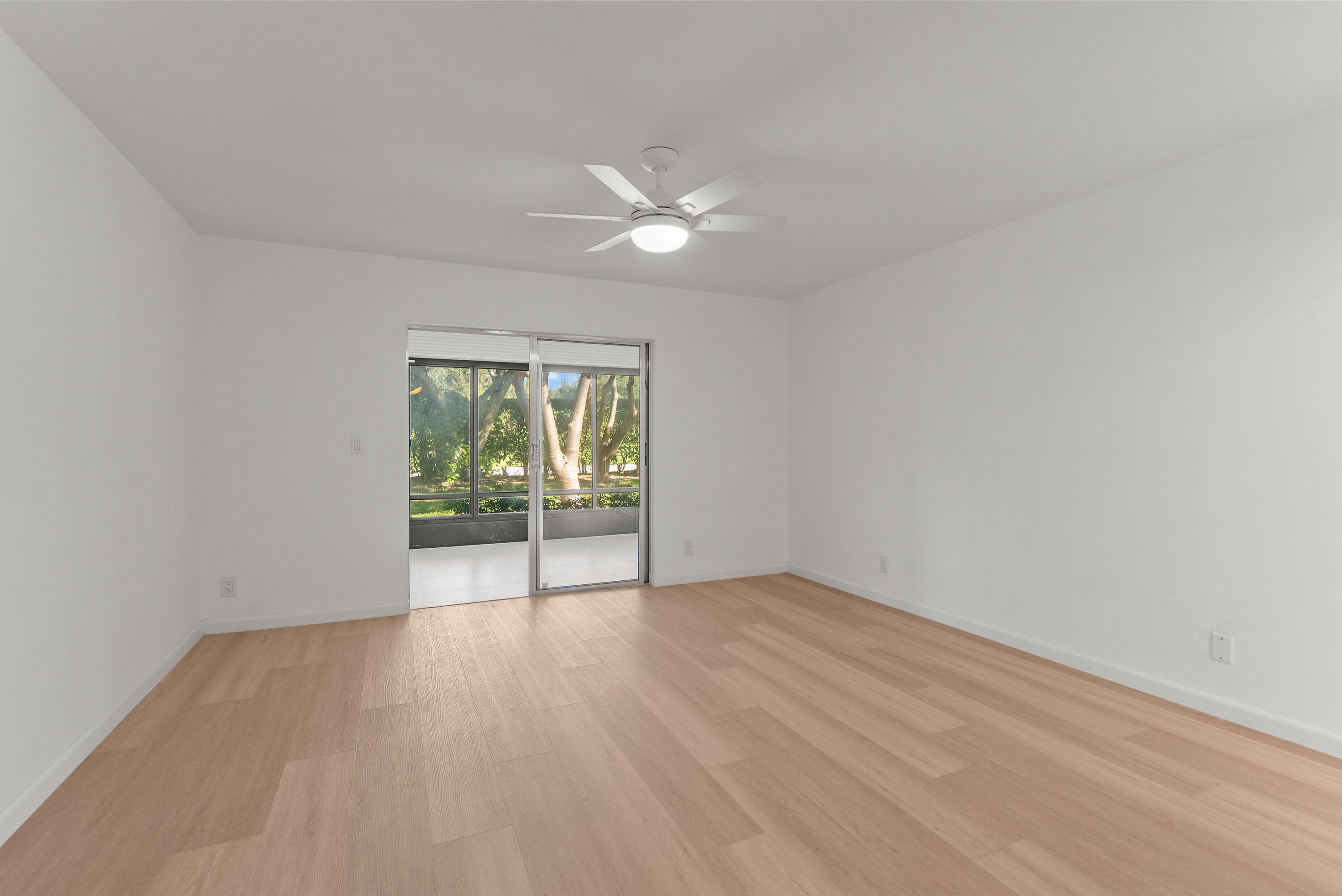 8273 Springtree Road Boca Raton, FL 33496 - Photo 23 of 36 a view of an empty room with wooden floor and a window