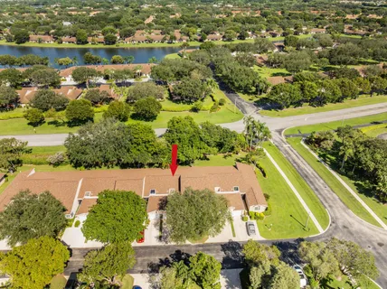 an aerial view of a residential houses with outdoor space and swimming pool