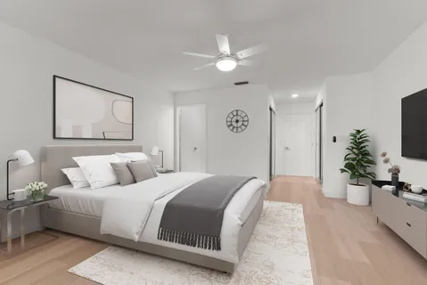 a spacious bedroom with a bed and a chandelier