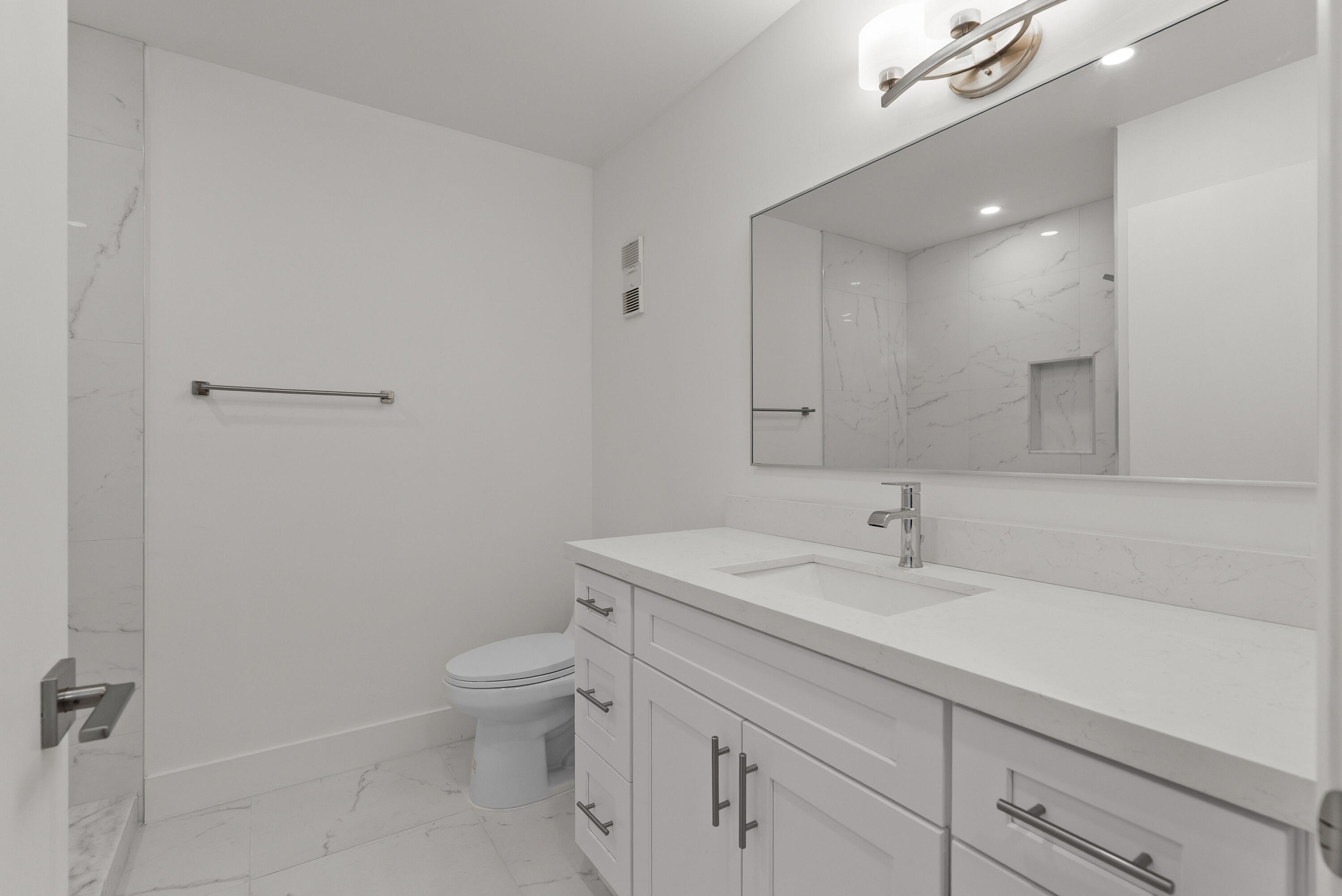 8273 Springtree Road Boca Raton, FL 33496 - Photo 9 of 36 a bathroom with a sink a toilet and a mirror