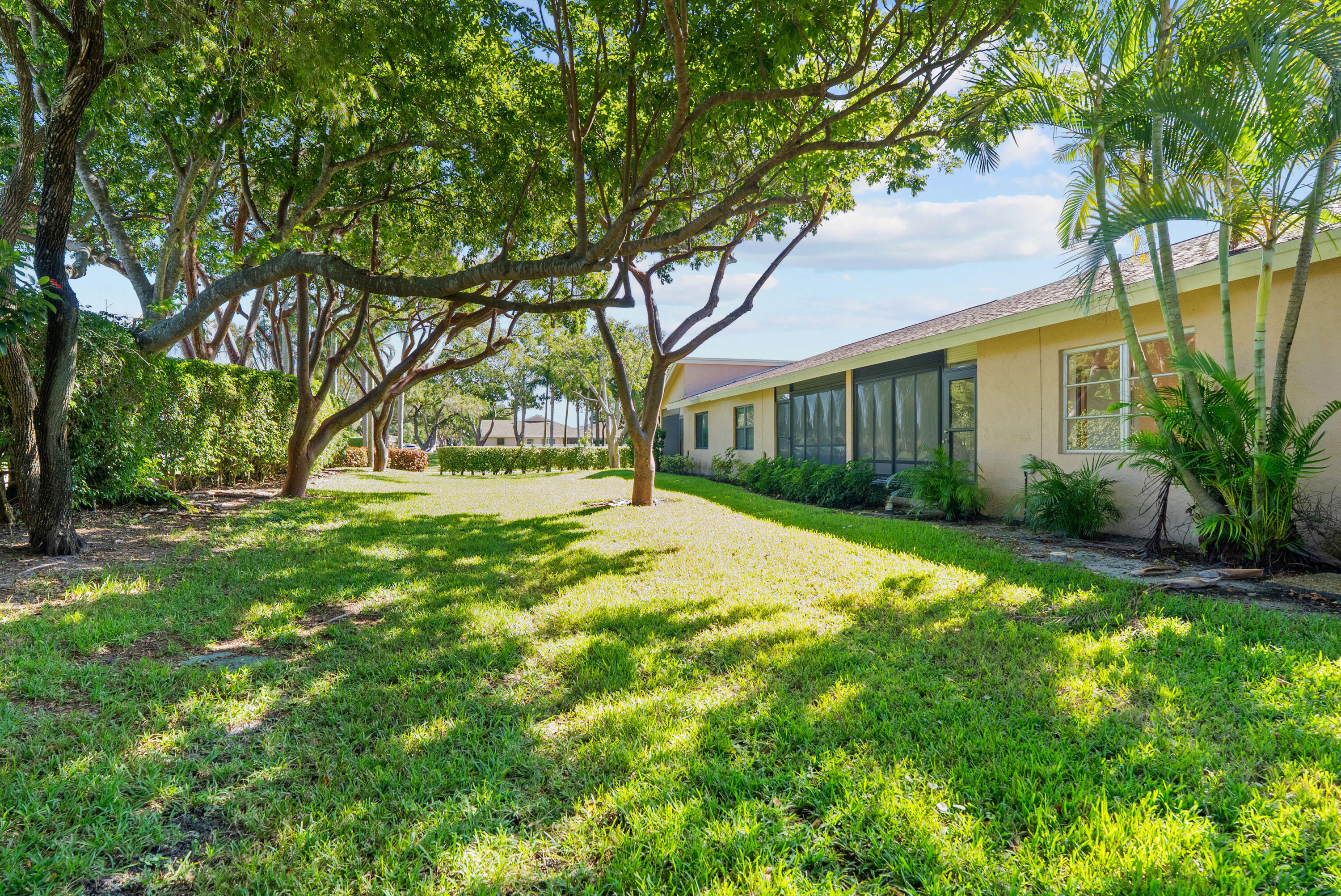 8273 Springtree Road Boca Raton, FL 33496 - Photo 10 of 36 a view of backyard of house with green space