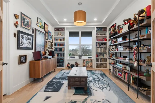 a living room with furniture and a book shelf