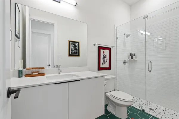 a bathroom with a sink toilet and shower