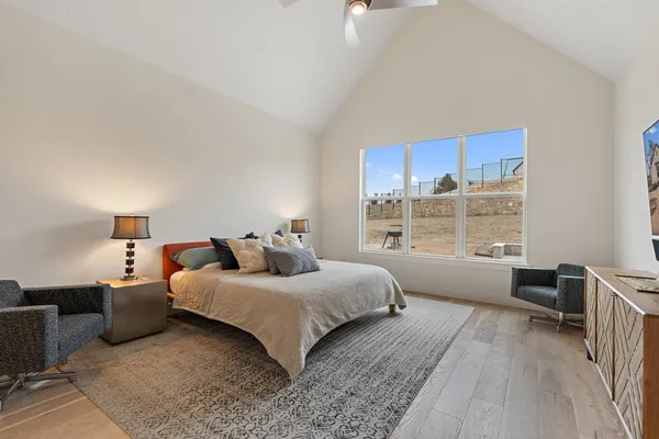 a bedroom with a bed and a large window