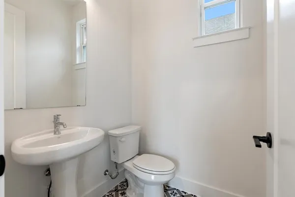 a bathroom with a sink toilet and a mirror