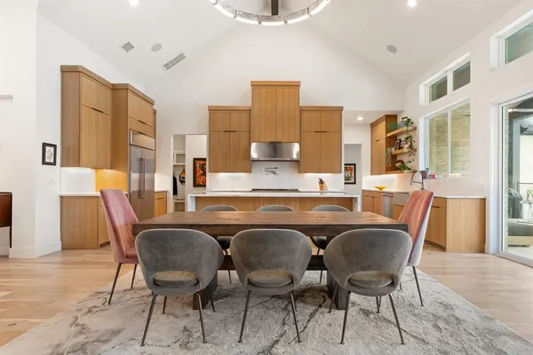 a dining room with furniture and wooden floor