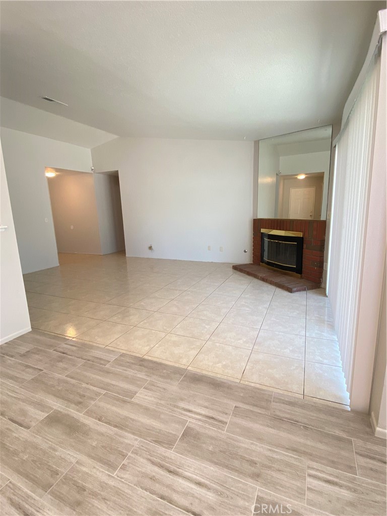 14663 Rio Grande Drive Moreno Valley, CA 92553 - Photo 3 of 15 a view of an empty room with wooden floor and a window