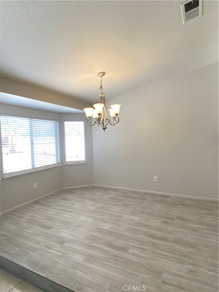 14663 Rio Grande Drive Moreno Valley, CA 92553 - Photo 4 of 15 wooden floor in an empty room