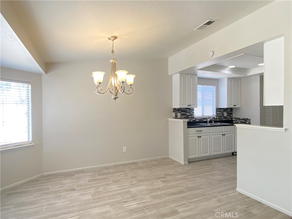 14663 Rio Grande Drive Moreno Valley, CA 92553 - Photo 5 of 15 a kitchen with a refrigerator and window
