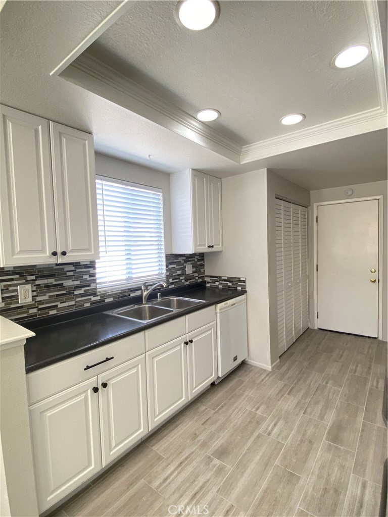 14663 Rio Grande Drive Moreno Valley, CA 92553 - Photo 6 of 15 a large white kitchen with a sink and cabinets