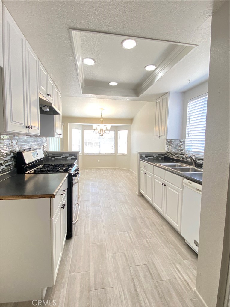 14663 Rio Grande Drive Moreno Valley, CA 92553 - Photo 7 of 15 a kitchen with stainless steel appliances a sink stove and cabinets