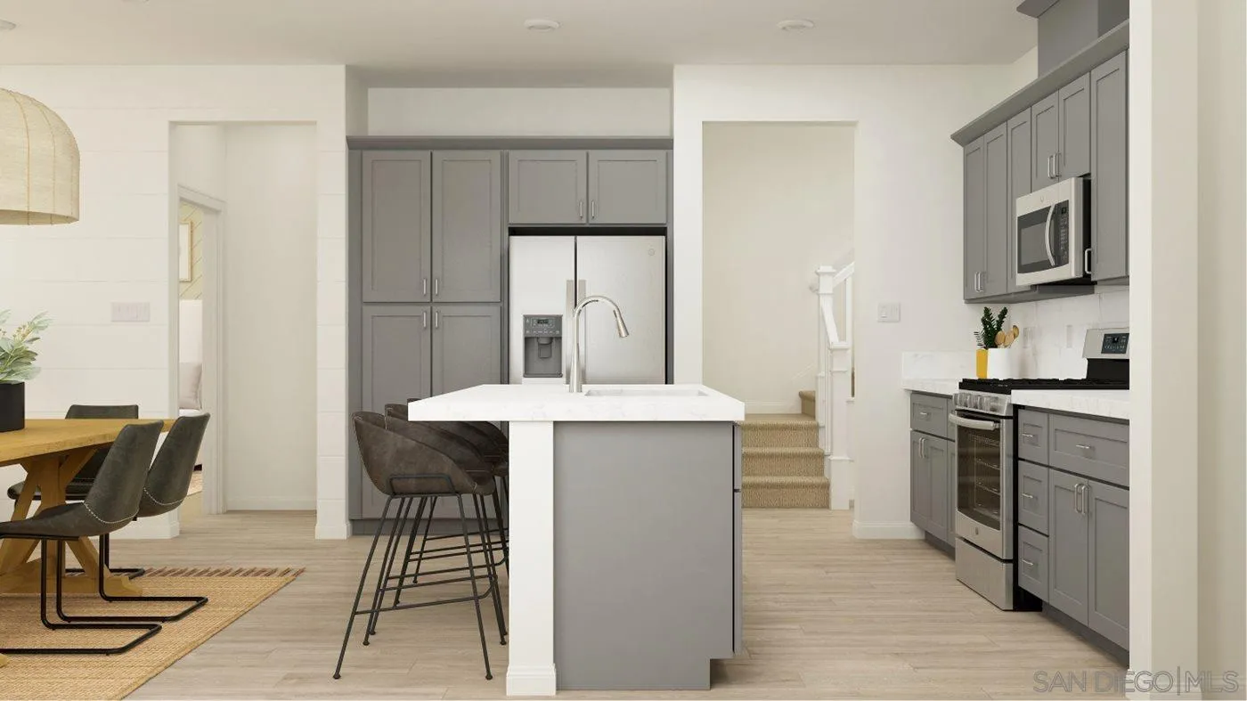 17254 Abbey Road Poway, CA 92064 - Photo 6 of 23 a kitchen with kitchen island a stove a refrigerator and a dining table