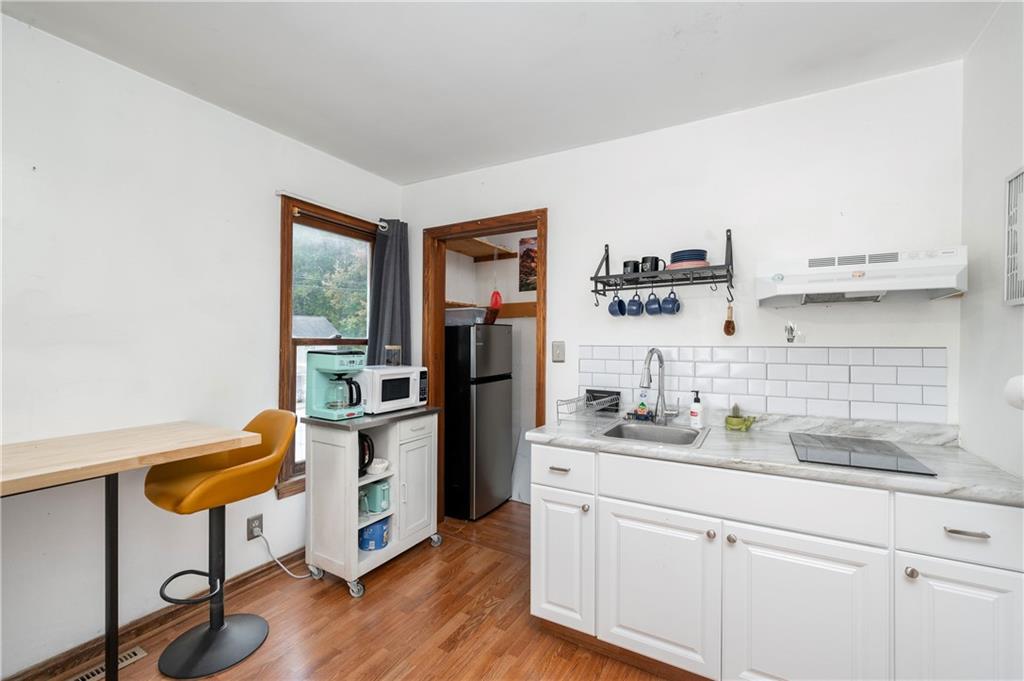 375 Main Street Volant, PA 16156 - Photo 22 of 34 a kitchen with a sink cabinets and wooden floor