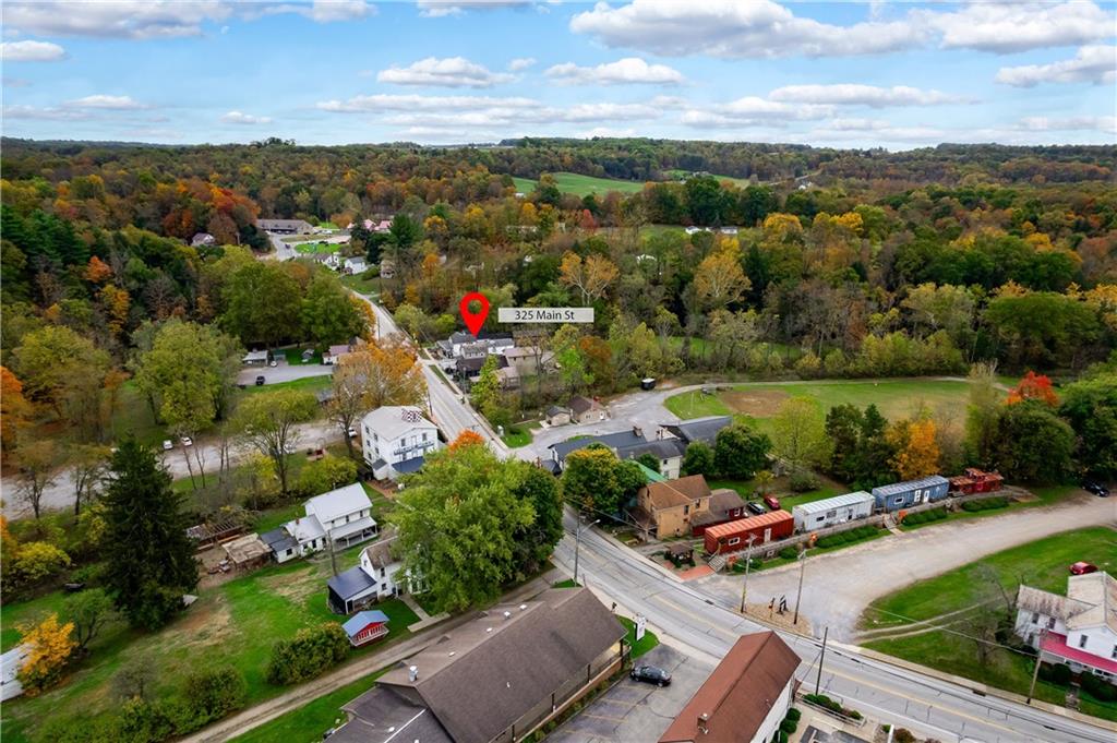 375 Main Street Volant, PA 16156 - Photo 34 of 34 an aerial view of a city with lots of residential buildings and mountain view in back