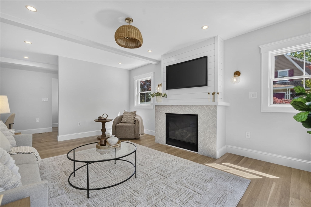 20 Saltonstall Road Medford, MA 02155 - Photo 3 of 41 a living room with furniture a flat screen tv and a fireplace