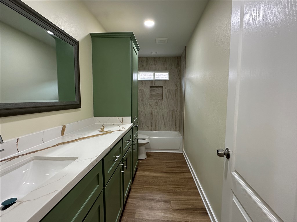 923 Craig Street, Unit B Corpus Christi, TX 78404 - Photo 6 of 9 a bathroom with a double vanity sink and mirror