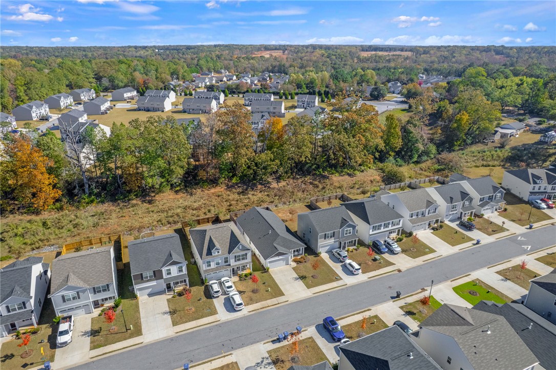 24 Chalet Court Anderson, SC 29621 - Photo 37 of 39 An aerial view of a vibrant neighborhood with homes lining the streets, surrounded by lush greenery.