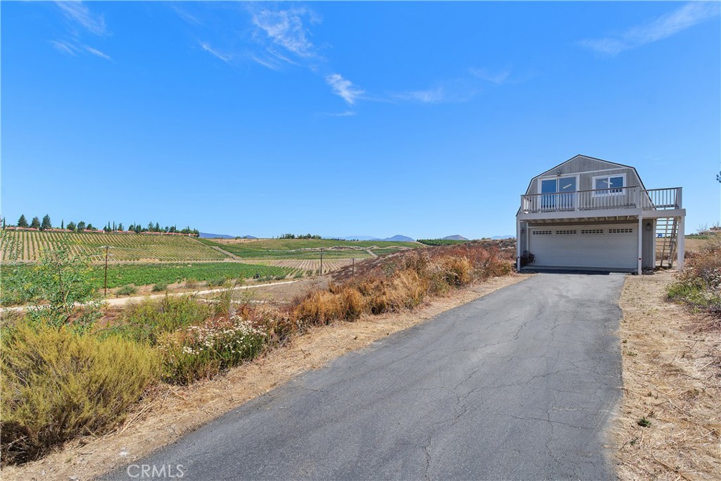34881 Los Nogales Road Temecula, CA 92592 - Photo 16 of 50 Permitted Barn/Workshop or Secondary 2 car Garage with a loft used as game room & office area. Double sklylights and decking with views.