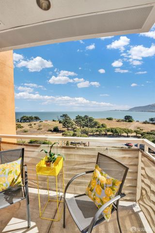 a view of a terrace with furniture and city view