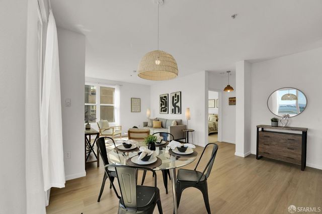 a view of a dining room with furniture and chandelier