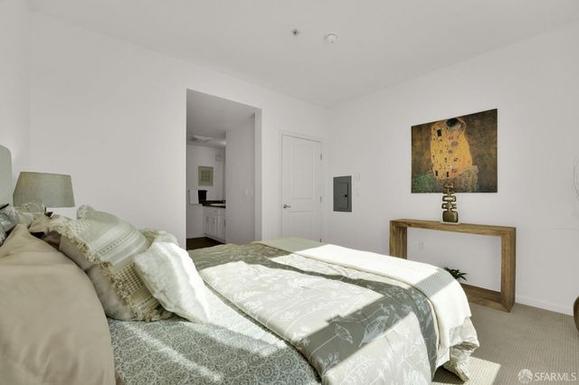 a bedroom with a bed and a flat screen tv