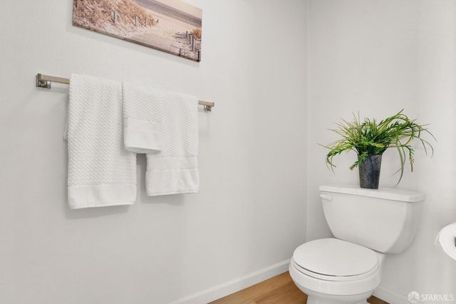a white toilet sitting next to a bathroom sink