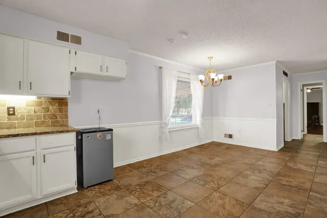 a view of a kitchen with marble kitchen and refrigerator