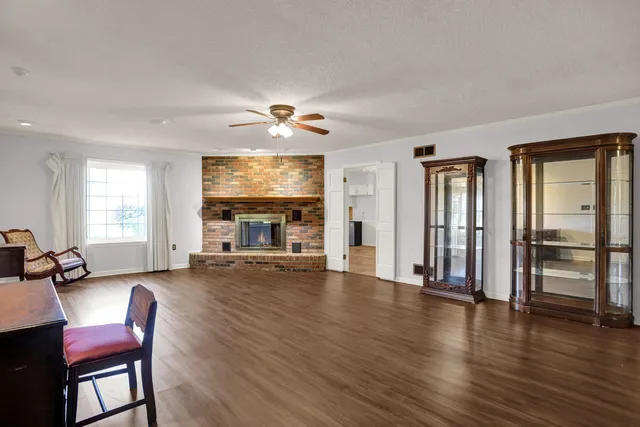 a view of a livingroom with furniture wooden floor and windows